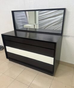 A dark brown wooden dresser featuring a wide white central drawer, accompanied by a large mirror with a matching rectangular frame.
