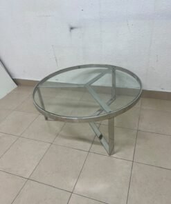 A round coffee table featuring a silver-colored metal frame (steel or chrome), a clear glass top, and a geometric crisscross base design. - Image 2