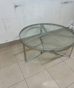 A round coffee table featuring a silver-colored metal frame (steel or chrome), a clear glass top, and a geometric crisscross base design. - Image 4