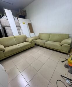 A light green (or light olive) velvet sofa set featuring a comfortable, wide design with prominent armrests.