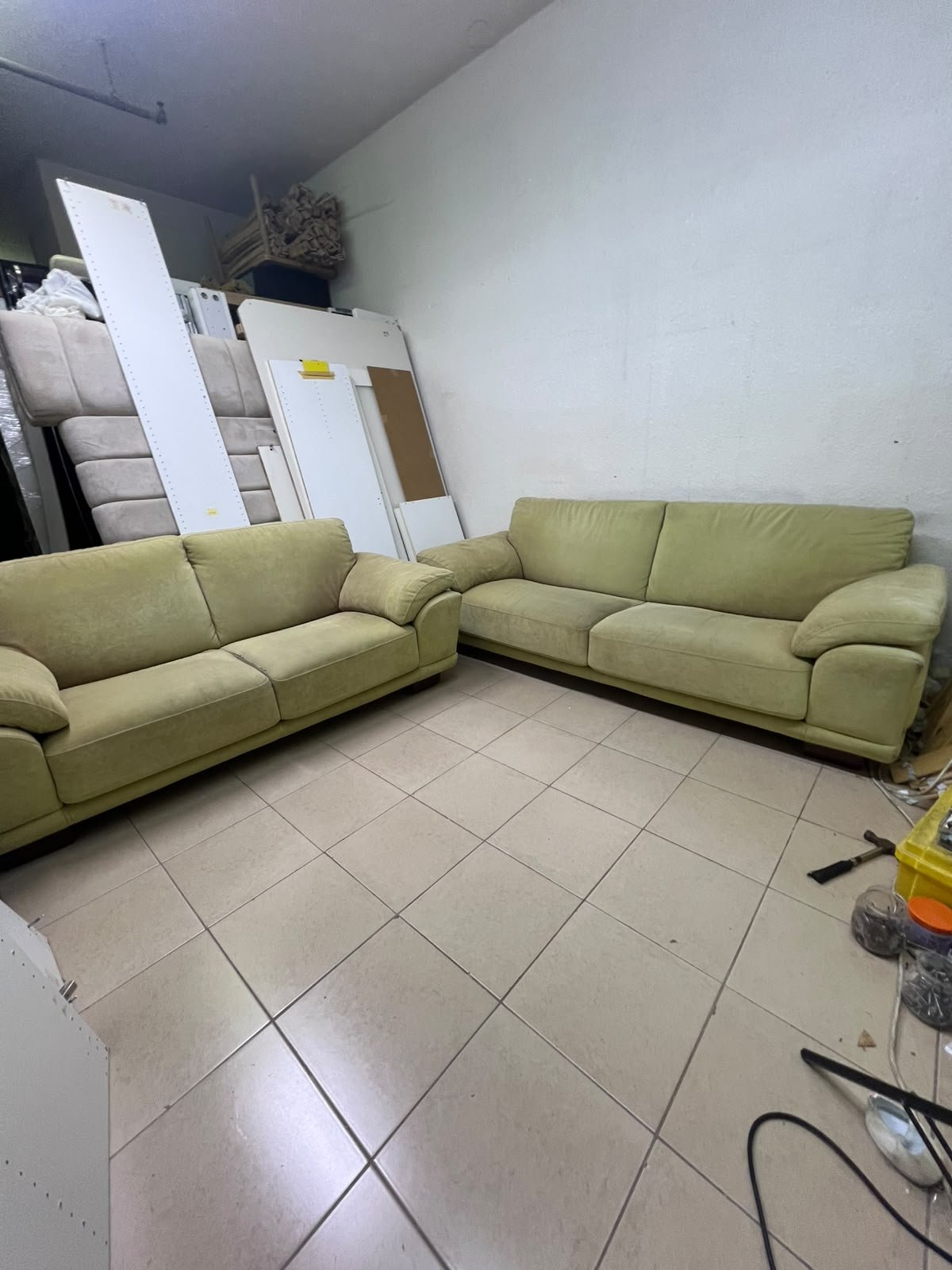 A light green (or light olive) velvet sofa set featuring a comfortable, wide design with prominent armrests.