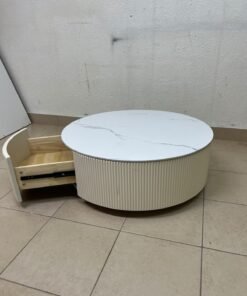 This round coffee table is elegant, featuring a cream-colored ribbed base and a stone tabletop with a marble-like pattern. - Image 3