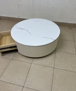 This round coffee table is elegant, featuring a cream-colored ribbed base and a stone tabletop with a marble-like pattern. - Image 10