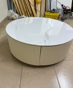 This round coffee table is elegant, featuring a cream-colored ribbed base and a stone tabletop with a marble-like pattern. - Image 4