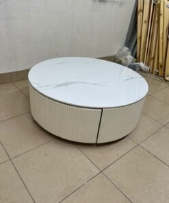 This round coffee table is elegant, featuring a cream-colored ribbed base and a stone tabletop with a marble-like pattern. - Image 5