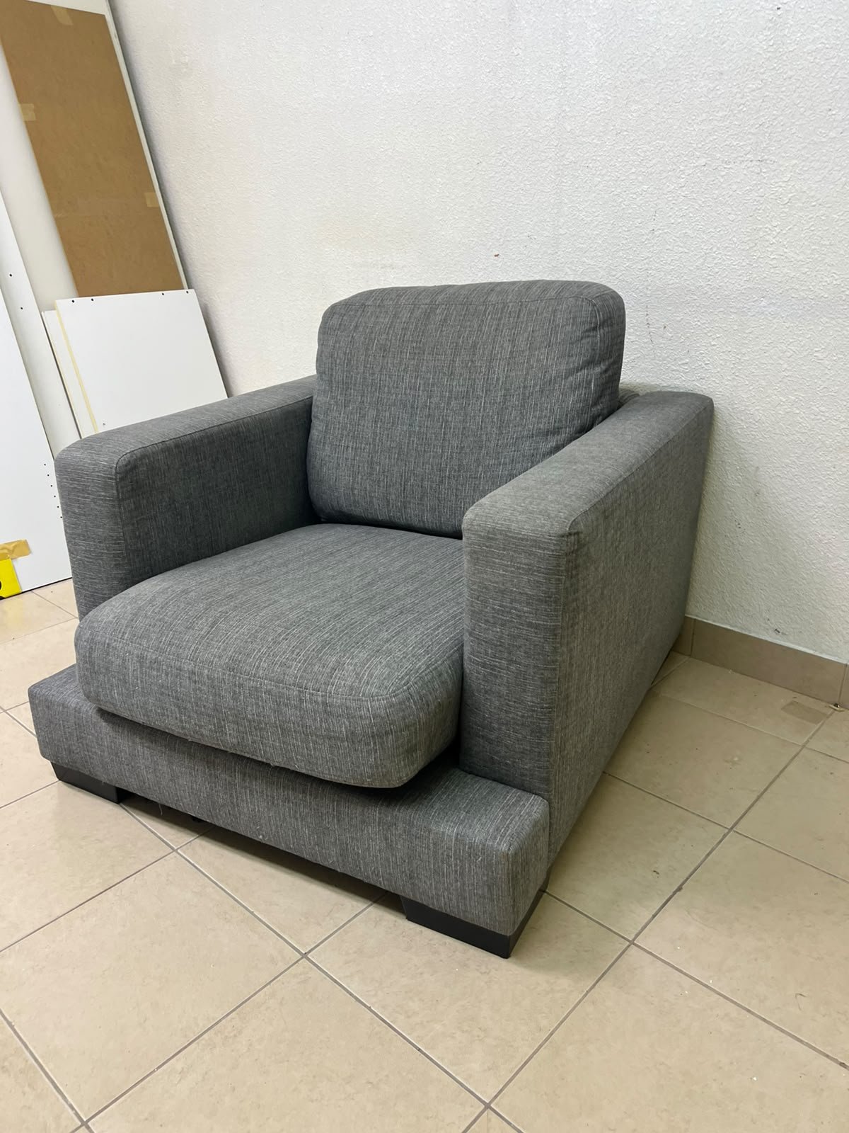 This is a single-seater chair (armchair) featuring a modern design, upholstered in gray fabric, with wide, square armrests. - Image 3