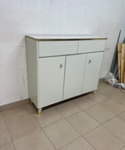 A white shoe cabinet or entryway storage unit (console) featuring a modern design, ribbed upper drawers, and gold accents on the handles and legs. - Image 2