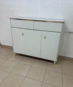 A white shoe cabinet or entryway storage unit (console) featuring a modern design, ribbed upper drawers, and gold accents on the handles and legs. - Image 3