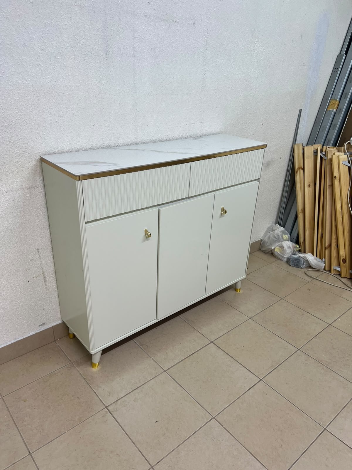 A white shoe cabinet or entryway storage unit (console) featuring a modern design, ribbed upper drawers, and gold accents on the handles and legs. - Image 11