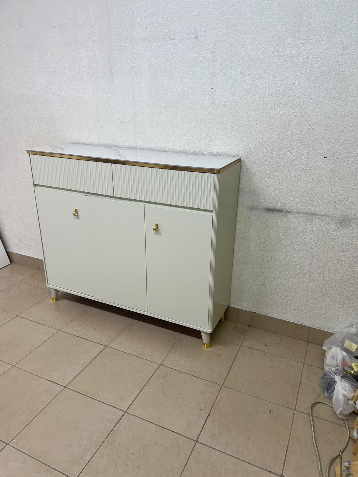 A white shoe cabinet or entryway storage unit (console) featuring a modern design, ribbed upper drawers, and gold accents on the handles and legs. - Image 10