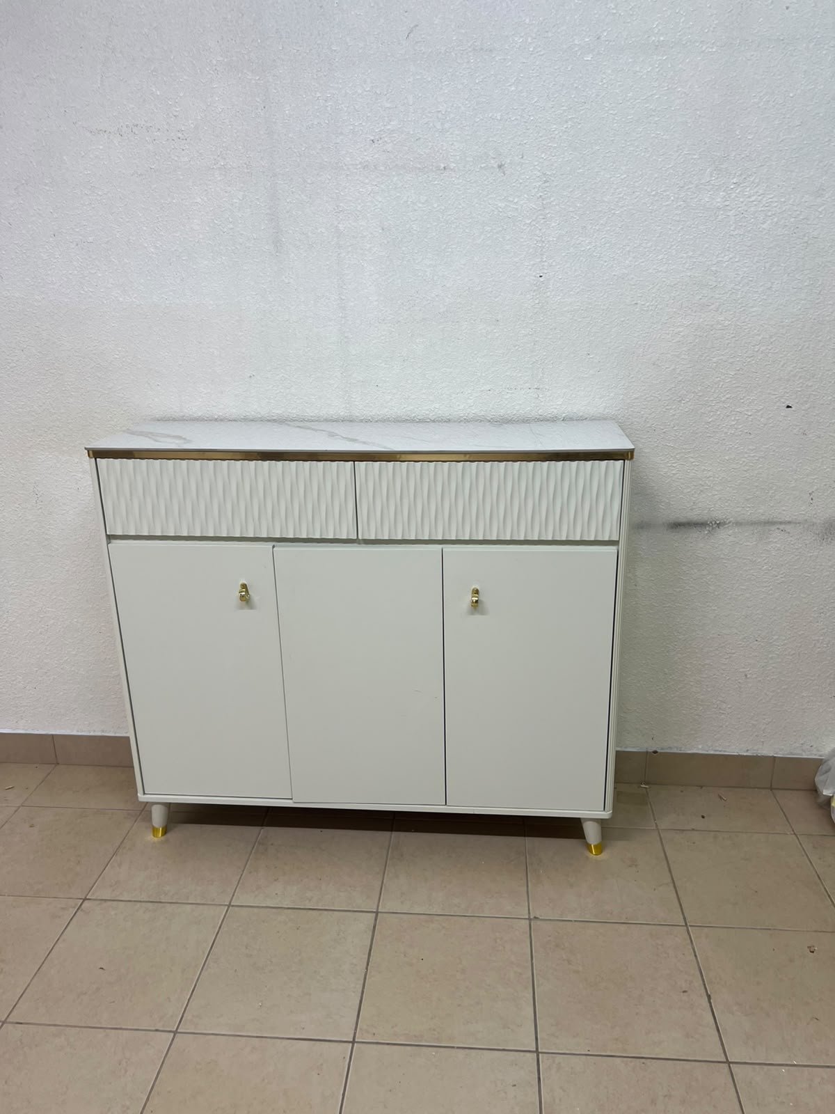 A white shoe cabinet or entryway storage unit (console) featuring a modern design, ribbed upper drawers, and gold accents on the handles and legs. - Image 8
