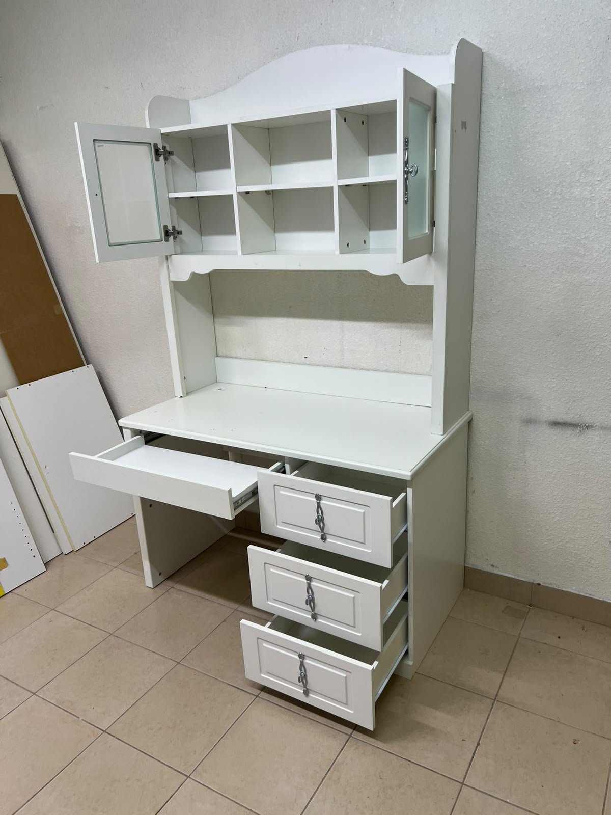 A complete white study desk featuring an overhead hutch, distinguished by its upper cabinets with glass doors and decorative handles. - Image 3