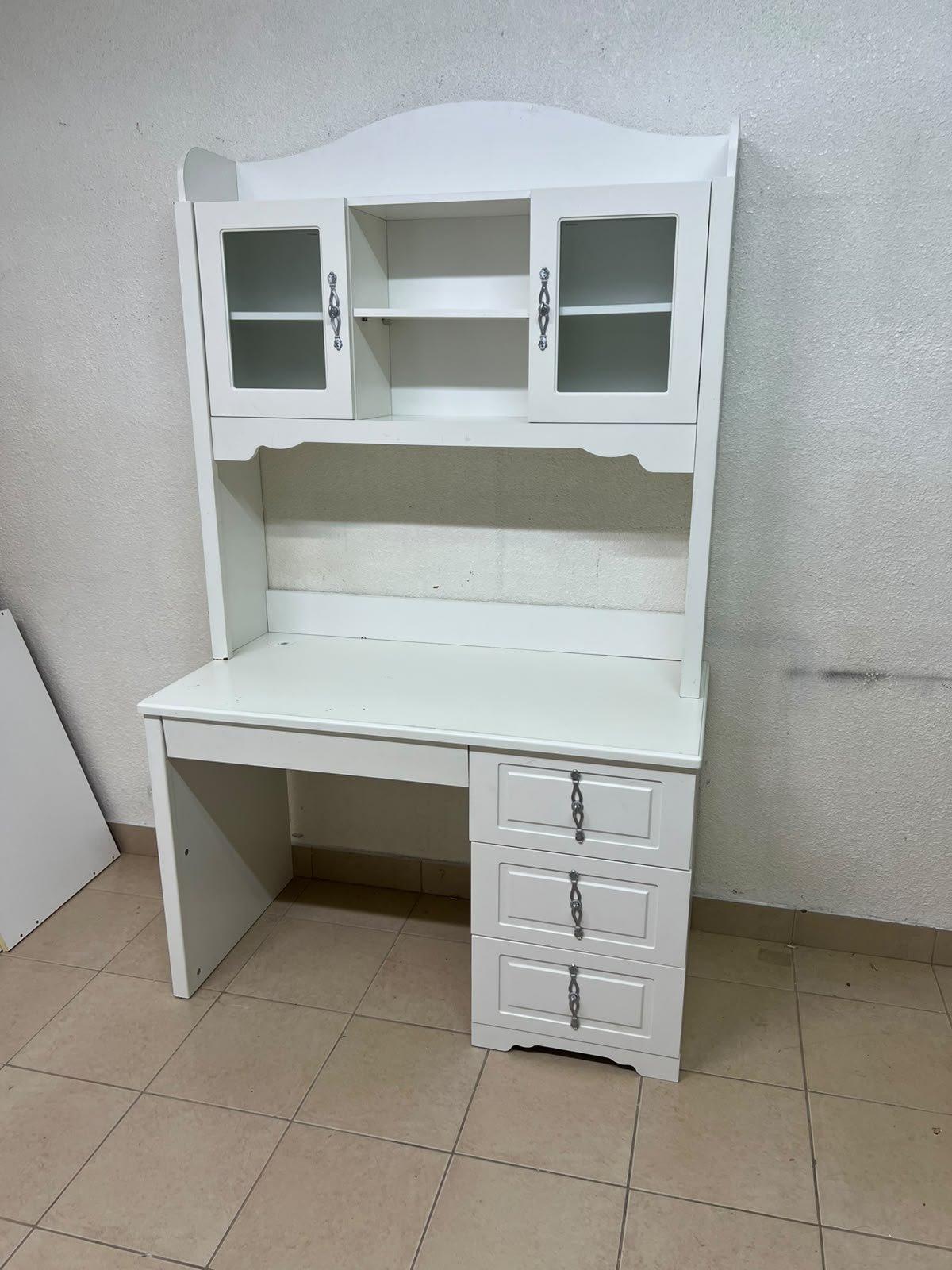A complete white study desk featuring an overhead hutch, distinguished by its upper cabinets with glass doors and decorative handles. - Image 8