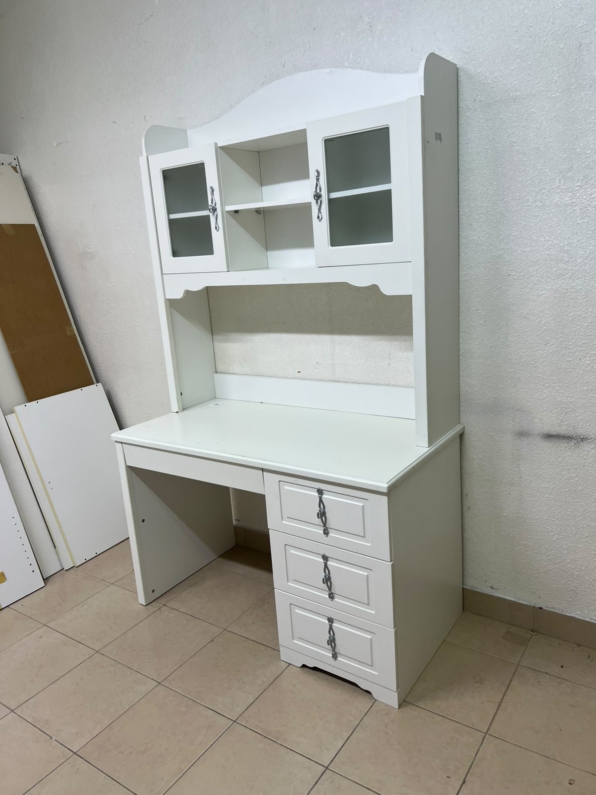 A complete white study desk featuring an overhead hutch, distinguished by its upper cabinets with glass doors and decorative handles. - Image 6