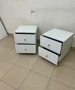 Modern white bedside tables featuring an elegant vertical ribbed design, with attractive gold accents on the handles and base. - Image 7