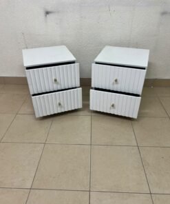 Modern white bedside tables featuring an elegant vertical ribbed design, with attractive gold accents on the handles and base. - Image 4