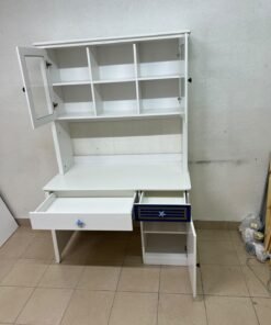 A white study desk featuring an overhead storage unit (a hutch or bookcase with glass-fronted cabinets), shelves, and a spacious work surface, along with a drawer and a lower cabinet accented with blue and gold star motifs and geometric patterns; a practical design suitable for children's or students' rooms for organizing books and school supplies. - Image 3