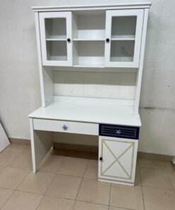 A white study desk featuring an overhead storage unit (a hutch or bookcase with glass-fronted cabinets), shelves, and a spacious work surface, along with a drawer and a lower cabinet accented with blue and gold star motifs and geometric patterns; a practical design suitable for children's or students' rooms for organizing books and school supplies. - Image 4