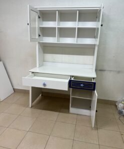 A white study desk featuring an overhead storage unit (a hutch or bookcase with glass-fronted cabinets), shelves, and a spacious work surface, along with a drawer and a lower cabinet accented with blue and gold star motifs and geometric patterns; a practical design suitable for children's or students' rooms for organizing books and school supplies. - Image 5