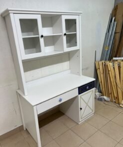 A white study desk featuring an overhead storage unit (a hutch or bookcase with glass-fronted cabinets), shelves, and a spacious work surface, along with a drawer and a lower cabinet accented with blue and gold star motifs and geometric patterns; a practical design suitable for children's or students' rooms for organizing books and school supplies. - Image 6