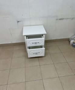 The elegant white side table with two drawers is distinguished by its decorative details and prominent silver handles. - Image 5