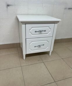 The elegant white side table with two drawers is distinguished by its decorative details and prominent silver handles. - Image 6
