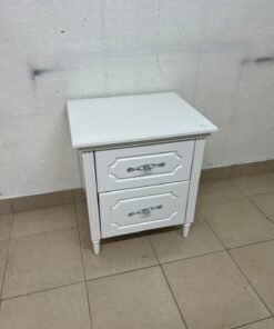 The elegant white side table with two drawers is distinguished by its decorative details and prominent silver handles. - Image 7