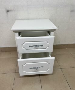 The elegant white side table with two drawers is distinguished by its decorative details and prominent silver handles. - Image 8