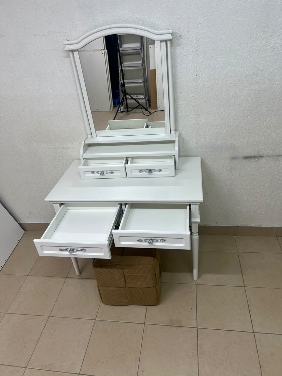 A white vanity table featuring a mirror and both upper and lower drawers, accompanied by a square brown stool upholstered in mesh fabric. - Image 3