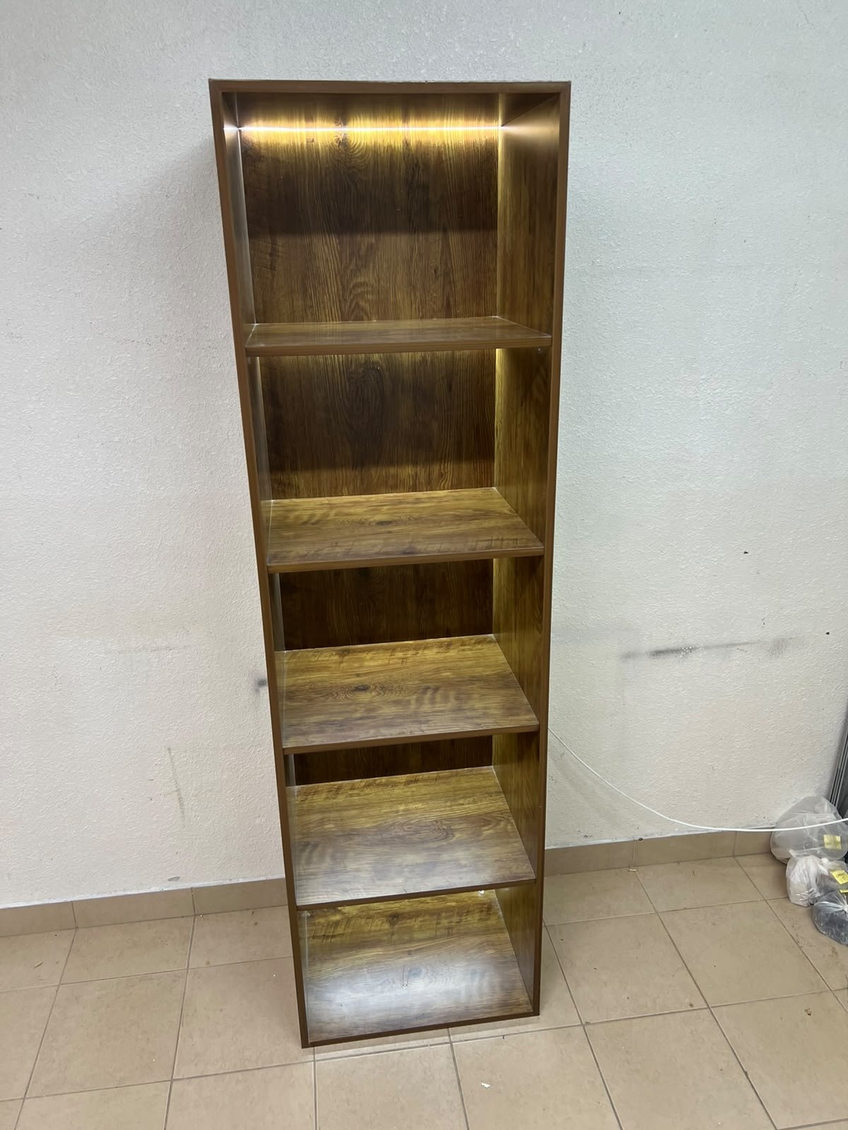 A vertical, 5-shelf wooden storage organizer featuring an open-back cube design and built-in LED lighting that adds a warm, modern touch to the upper shelves. - Image 2