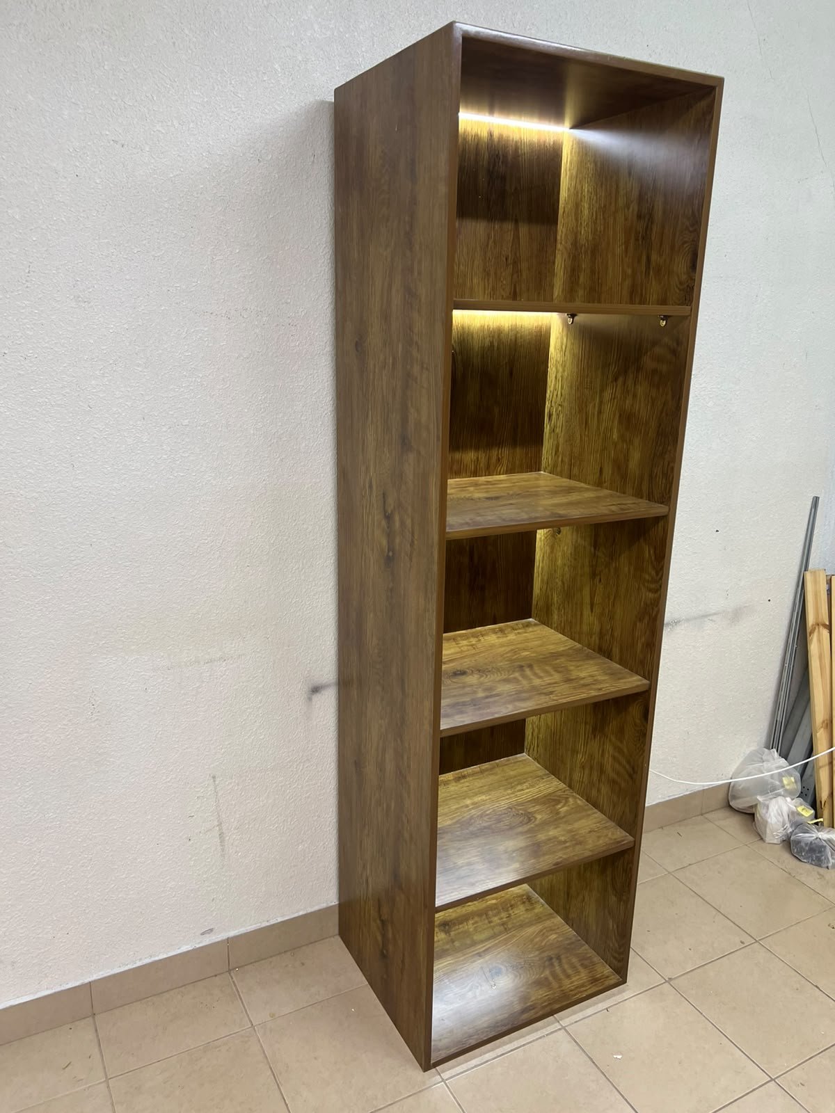 A vertical, 5-shelf wooden storage organizer featuring an open-back cube design and built-in LED lighting that adds a warm, modern touch to the upper shelves. - Image 3