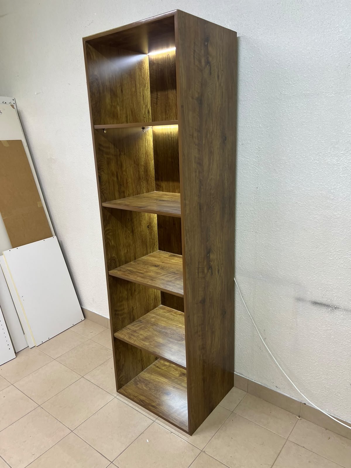 A vertical, 5-shelf wooden storage organizer featuring an open-back cube design and built-in LED lighting that adds a warm, modern touch to the upper shelves. - Image 4