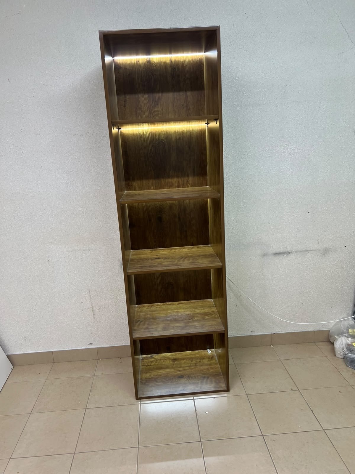 A vertical, 5-shelf wooden storage organizer featuring an open-back cube design and built-in LED lighting that adds a warm, modern touch to the upper shelves. - Image 6