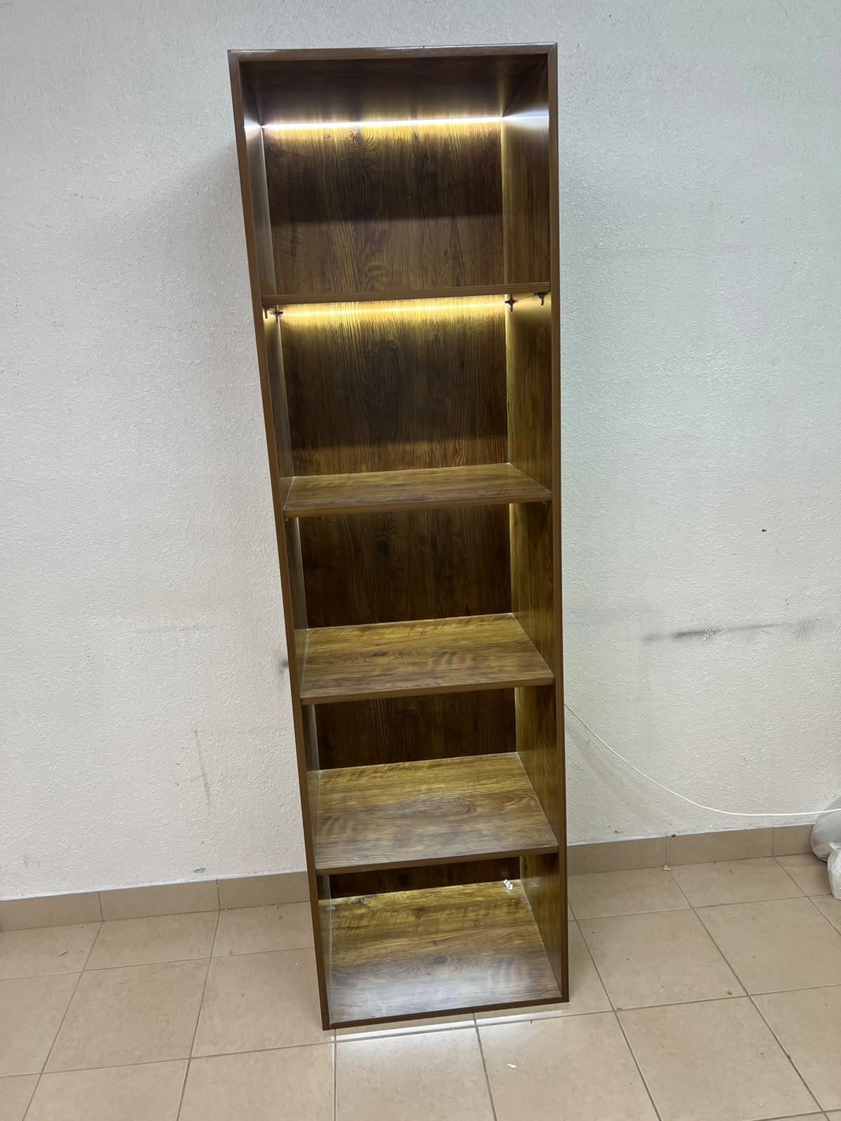 A vertical, 5-shelf wooden storage organizer featuring an open-back cube design and built-in LED lighting that adds a warm, modern touch to the upper shelves. - Image 8