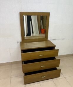 A wooden drawer unit (dressing table) featuring three drawers and metal handles, accompanied by a square mirror with a matching wooden frame—resembling designs found at brands like Pan Emirates or Home Centre. - Image 3
