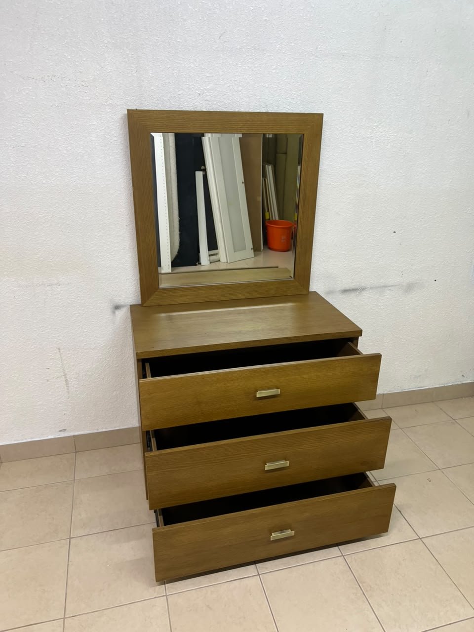 A wooden drawer unit (dressing table) featuring three drawers and metal handles, accompanied by a square mirror with a matching wooden frame—resembling designs found at brands like Pan Emirates or Home Centre. - Image 3