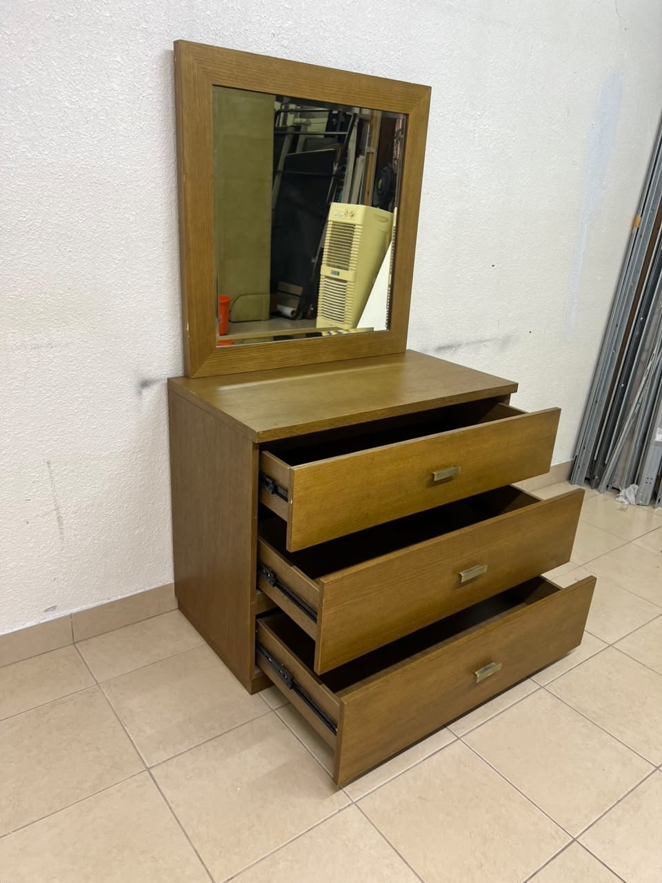 A wooden drawer unit (dressing table) featuring three drawers and metal handles, accompanied by a square mirror with a matching wooden frame—resembling designs found at brands like Pan Emirates or Home Centre. - Image 5