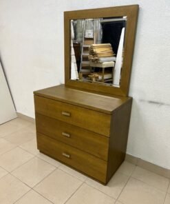 A wooden drawer unit (dressing table) featuring three drawers and metal handles, accompanied by a square mirror with a matching wooden frame—resembling designs found at brands like Pan Emirates or Home Centre.