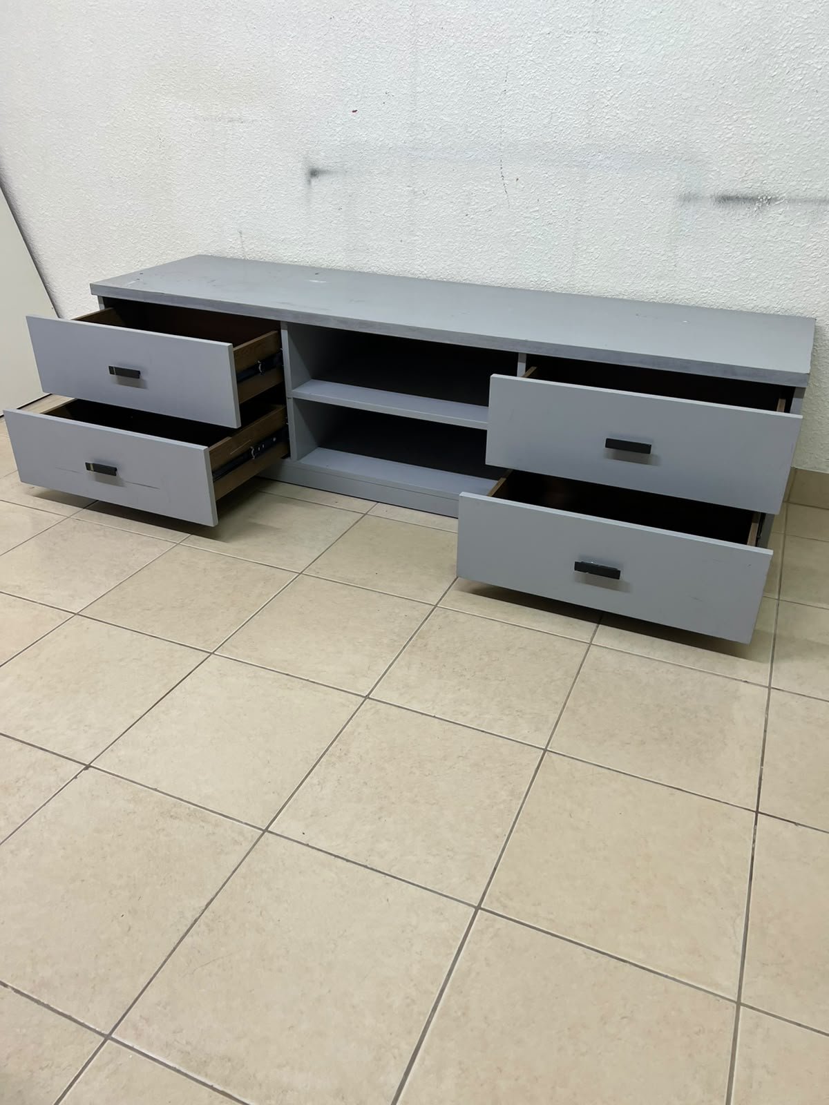 A grey TV stand featuring a modern design and side drawers equipped with stylish black handles. - Image 7