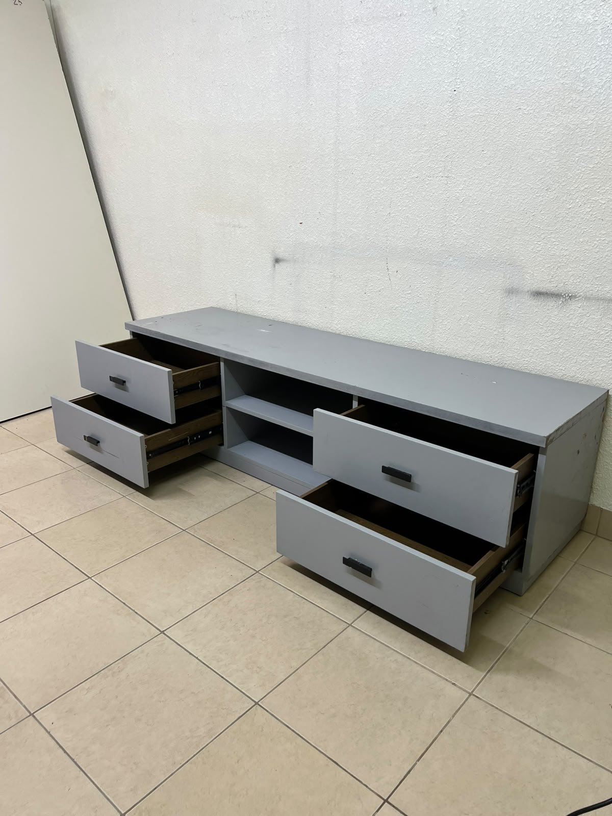 A grey TV stand featuring a modern design and side drawers equipped with stylish black handles. - Image 8