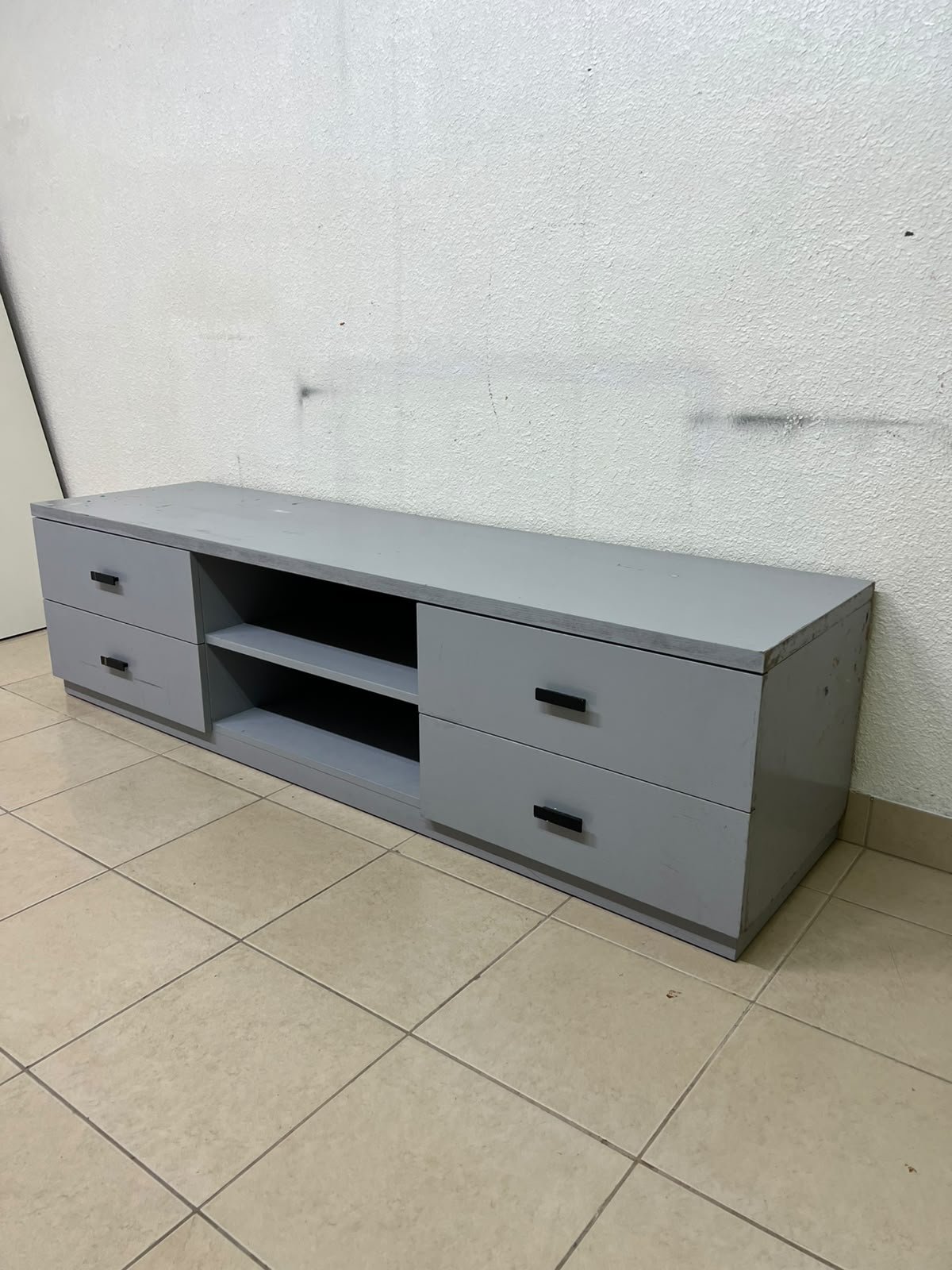 A grey TV stand featuring a modern design and side drawers equipped with stylish black handles. - Image 9