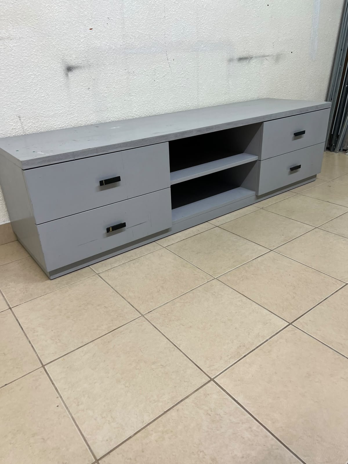 A grey TV stand featuring a modern design and side drawers equipped with stylish black handles. - Image 10