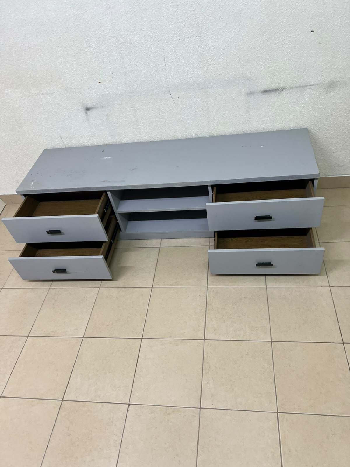 A grey TV stand featuring a modern design and side drawers equipped with stylish black handles. - Image 3