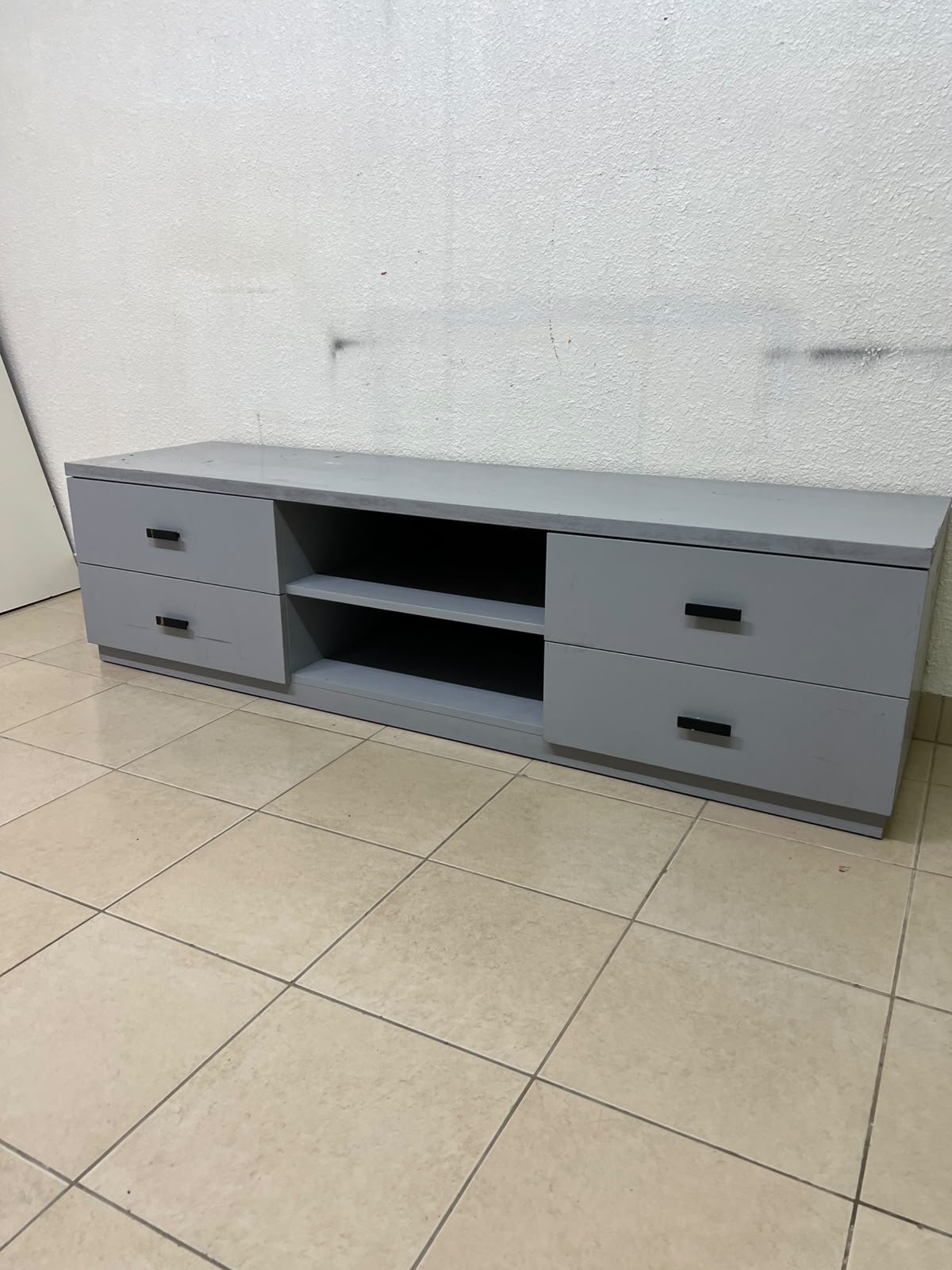A grey TV stand featuring a modern design and side drawers equipped with stylish black handles. - Image 4