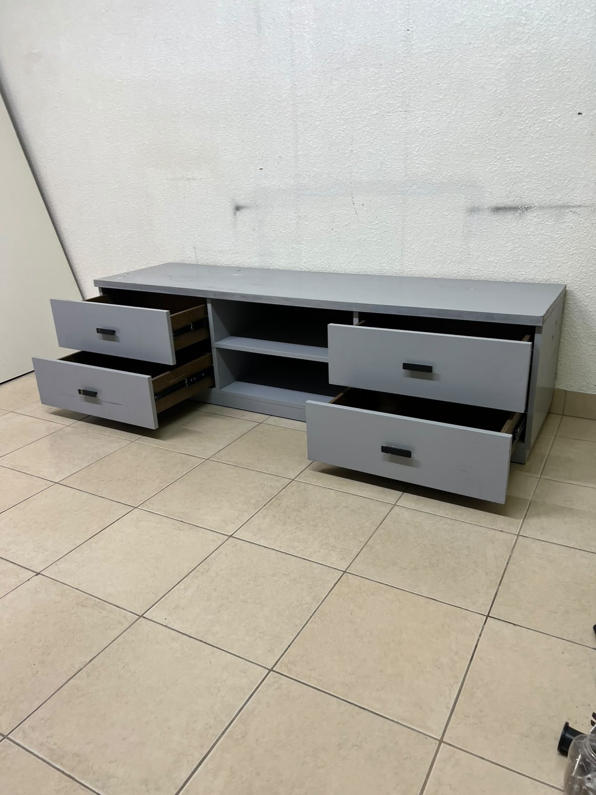 A grey TV stand featuring a modern design and side drawers equipped with stylish black handles. - Image 5