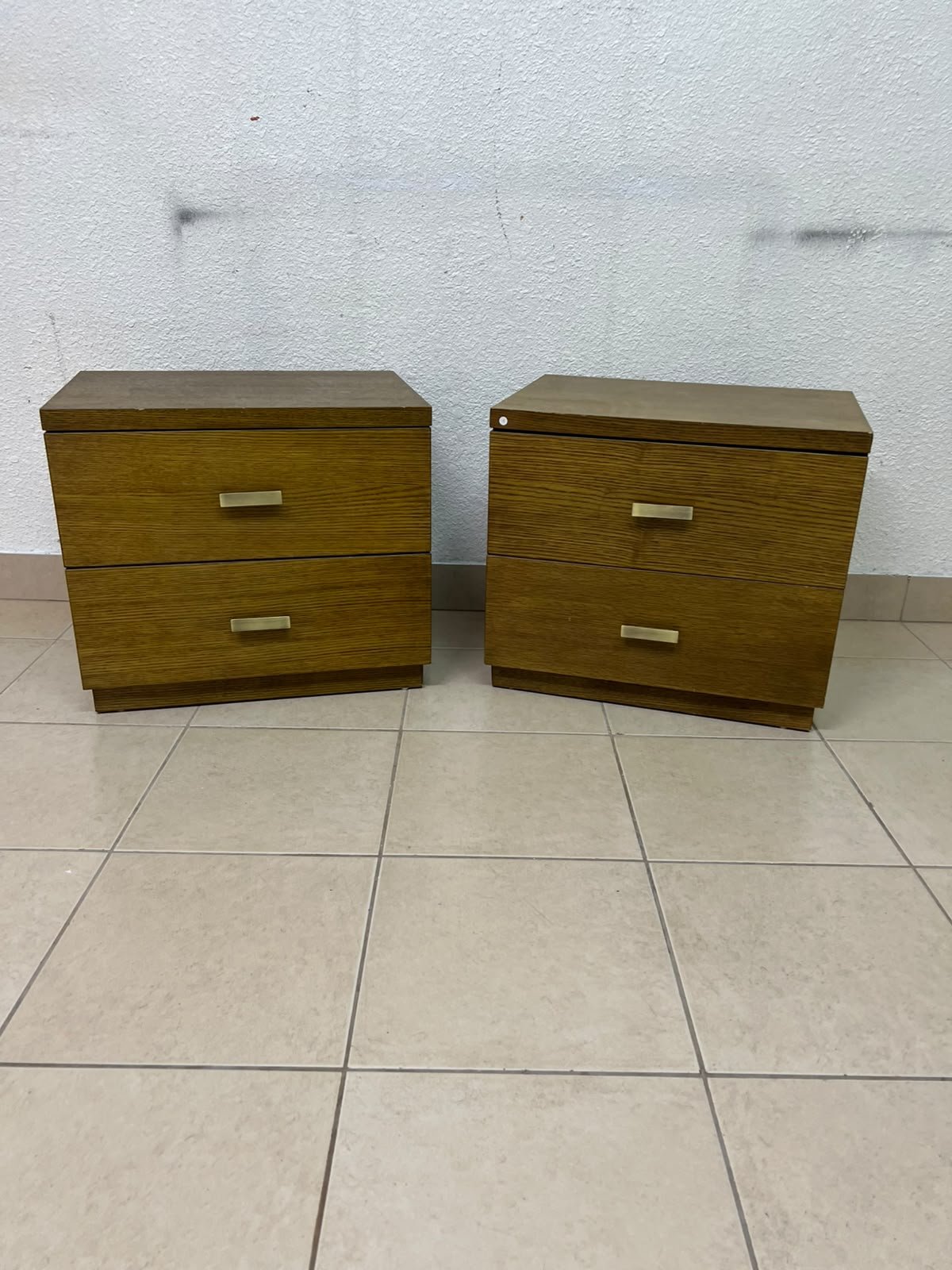 Two wooden side tables in a warm brown hue, featuring an elegant design with two drawers and distinctive metal handles. - Image 2