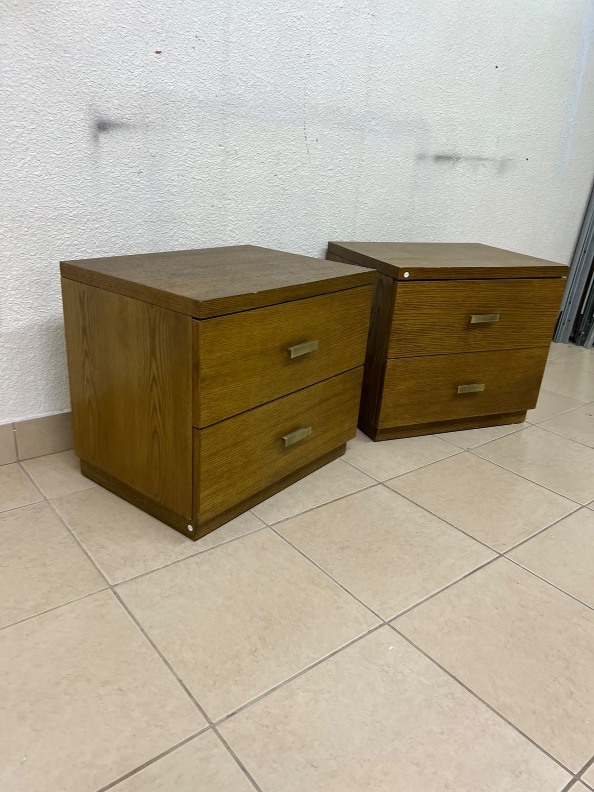 Two wooden side tables in a warm brown hue, featuring an elegant design with two drawers and distinctive metal handles. - Image 4