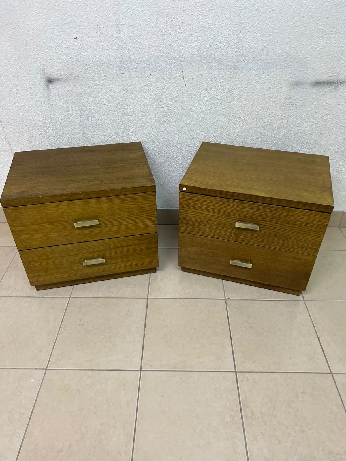 Two wooden side tables in a warm brown hue, featuring an elegant design with two drawers and distinctive metal handles. - Image 5