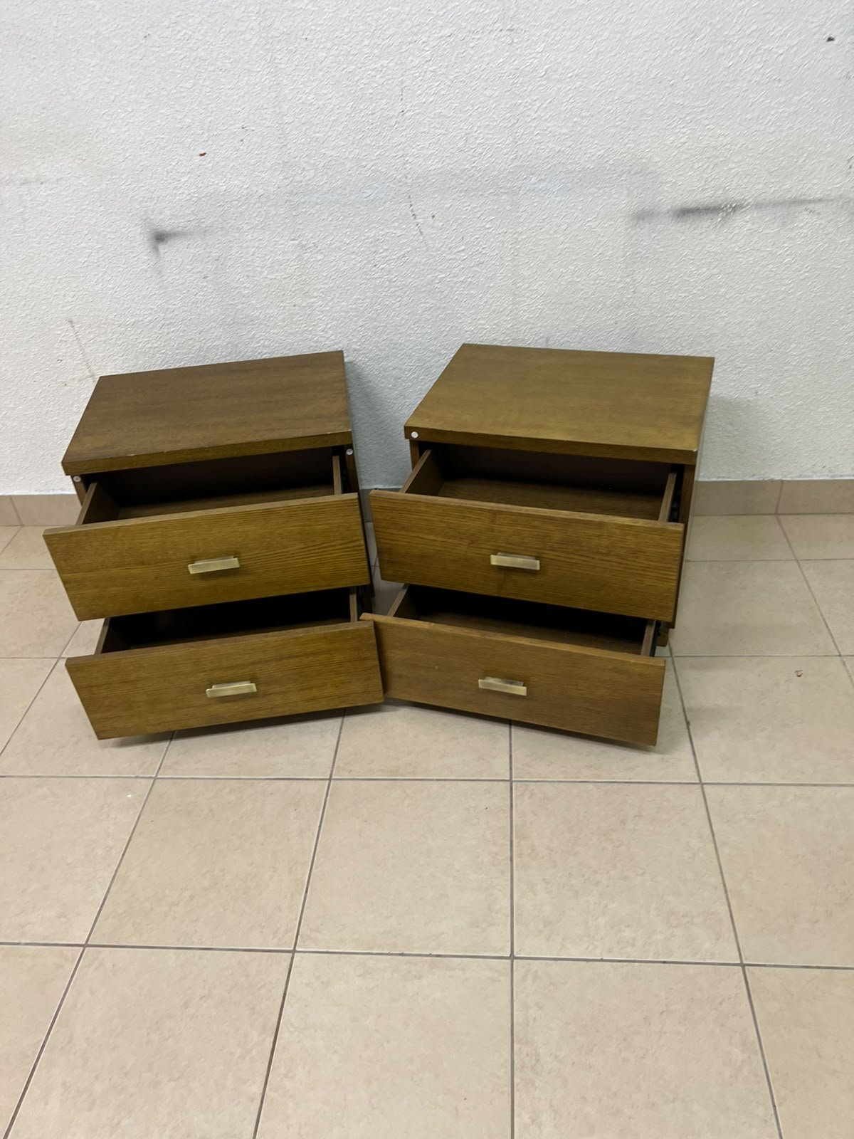 Two wooden side tables in a warm brown hue, featuring an elegant design with two drawers and distinctive metal handles. - Image 6