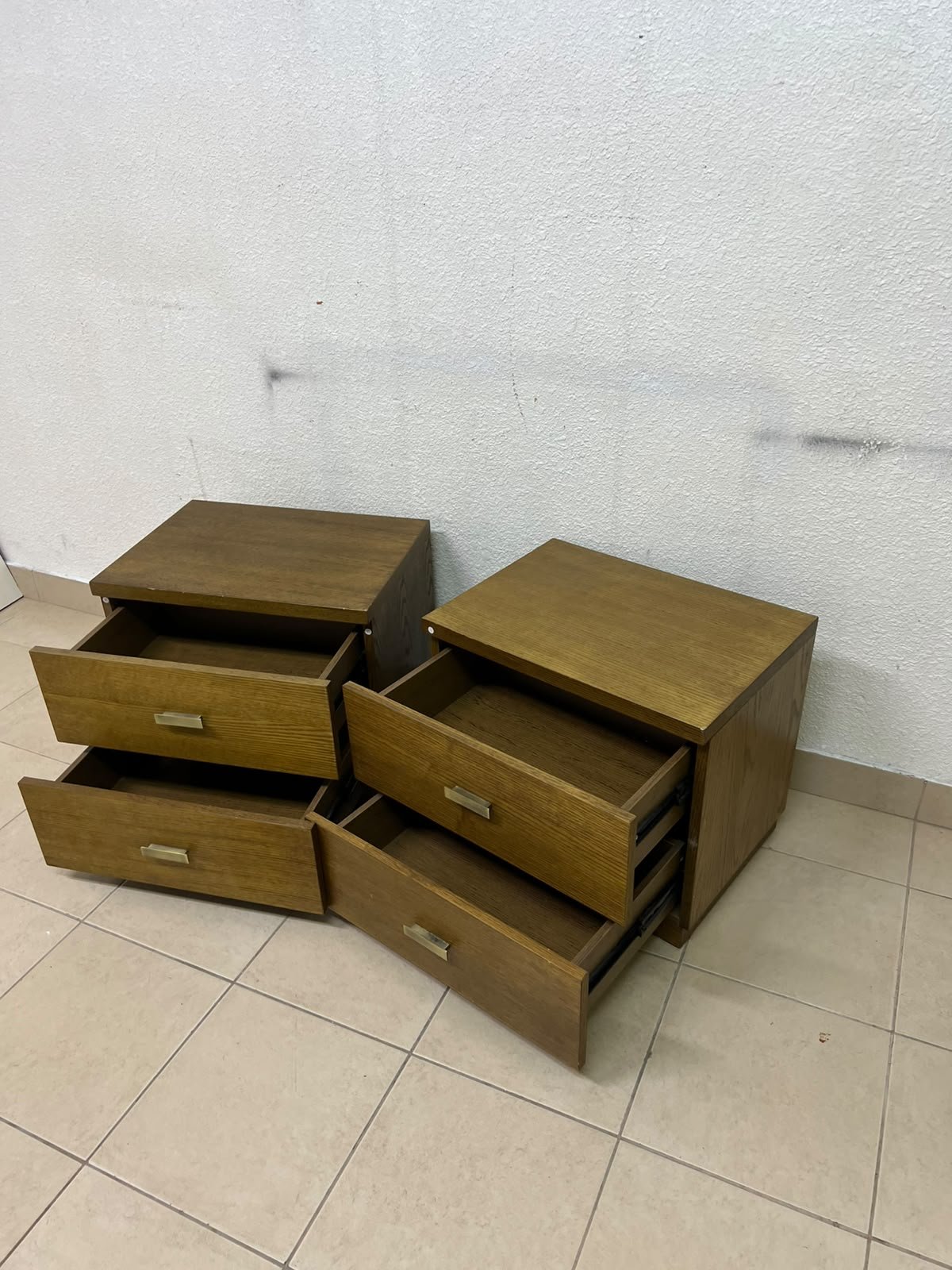 Two wooden side tables in a warm brown hue, featuring an elegant design with two drawers and distinctive metal handles. - Image 8